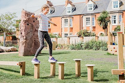 Girl balancing on stepping logs