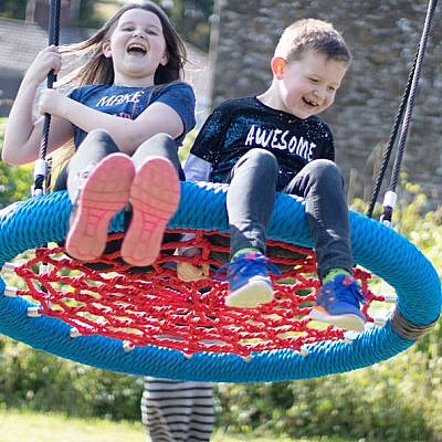 Children Playing on Bird's Nest Swing