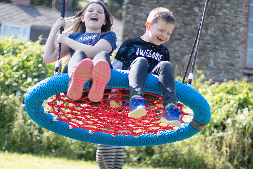 Children Playing on Bird's Nest Swing