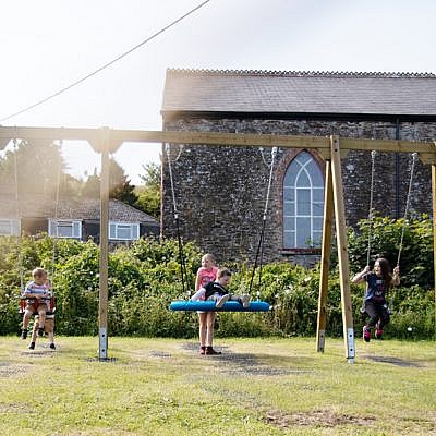 Children Playing on Family Swing