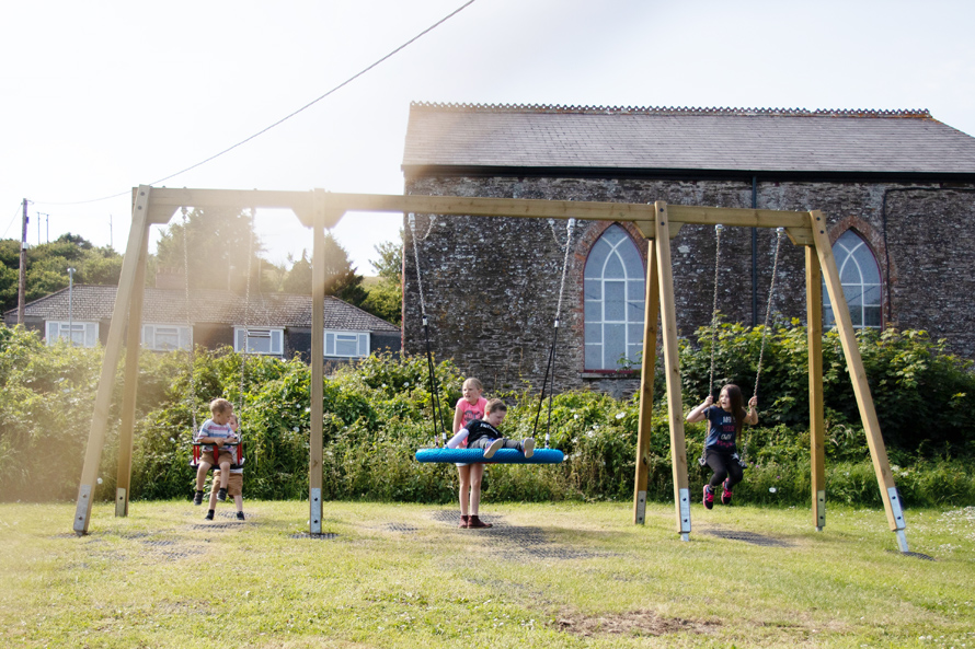 Children Playing on Family Swing