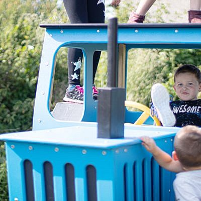 Little Boys Playing on Playground Tractor