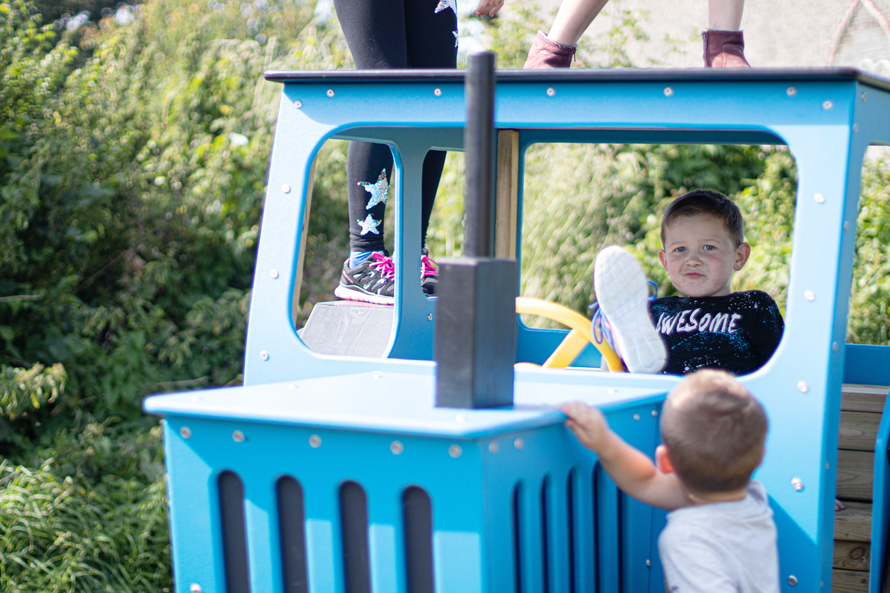 Little Boys Playing on Playground Tractor