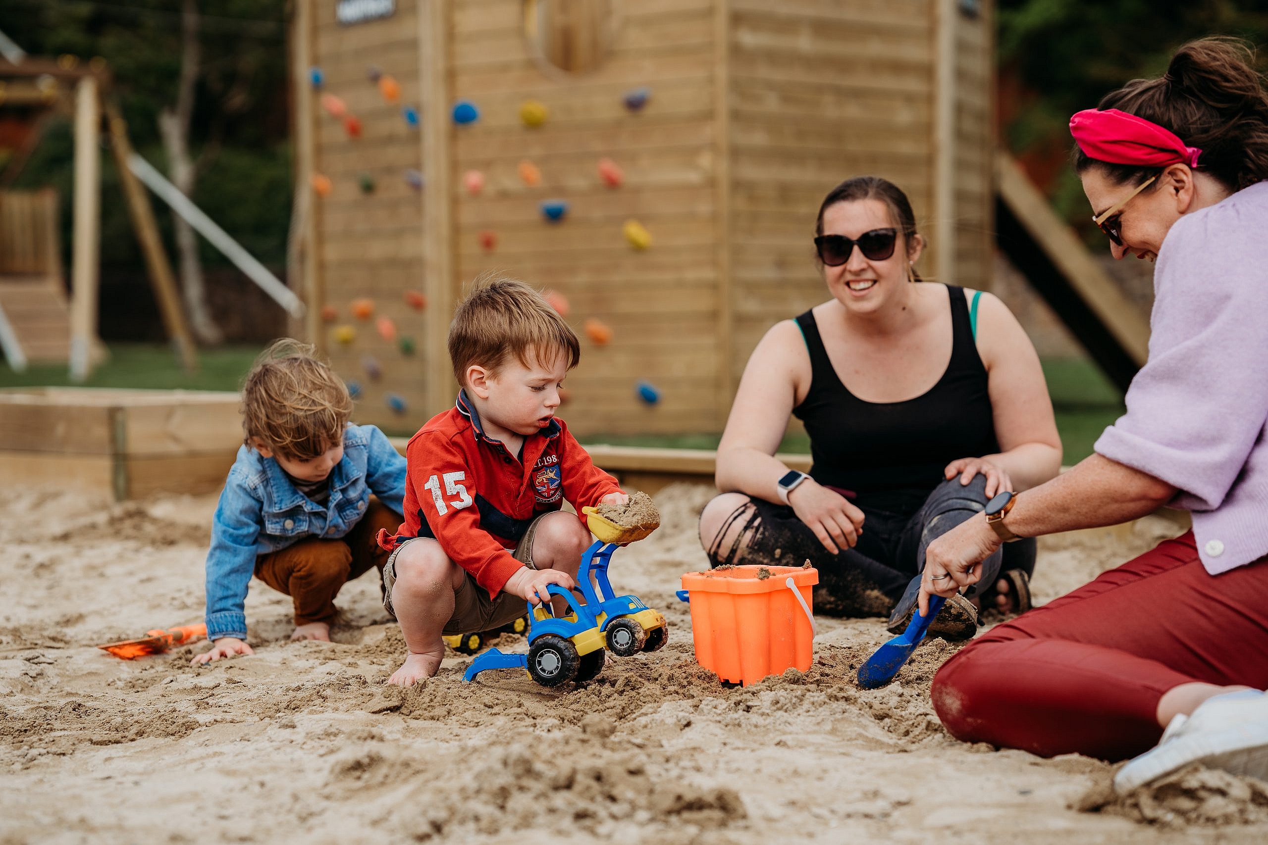 family enjoying playing in the sand.