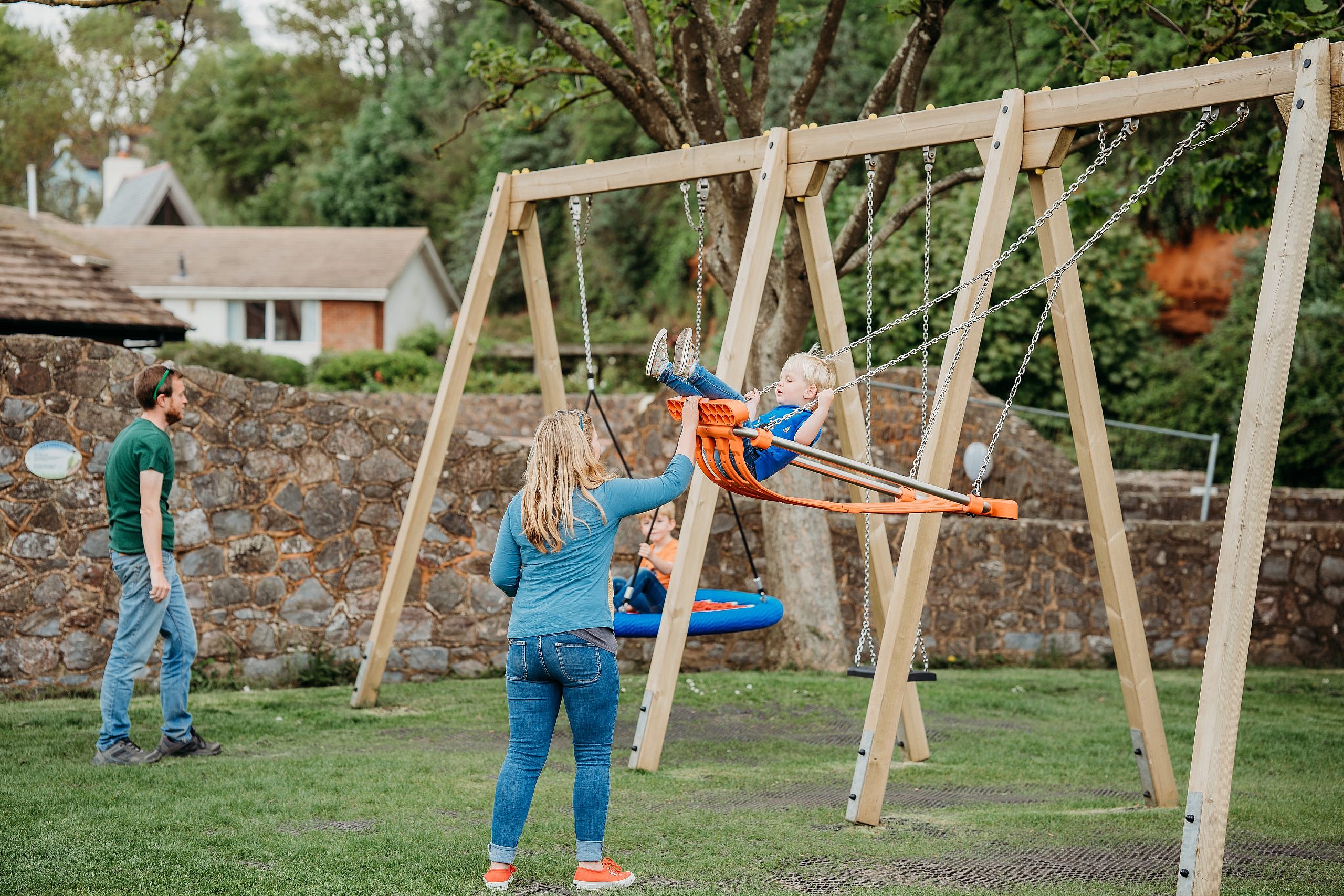 Children on swings at The Ham Play Area, Sidmouth.