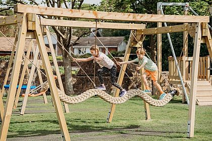 Two Children Swinging on the Snake Rope Swing