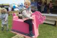 Little Boy Playing on Pink Pig Rocker